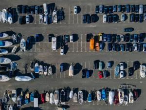 aerial view of boats and cars in parking lot